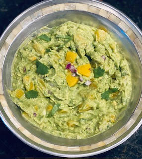 guacamole with fresh chopped peaches and fresh cilantro